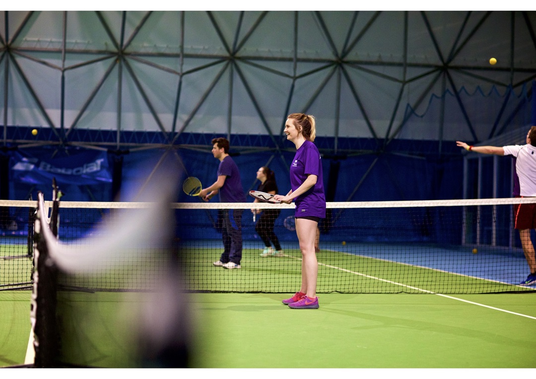 Emma playing on an indoor court